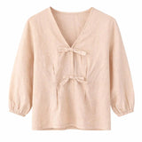 Beige blouse with bow details on a white background