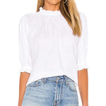 Woman wearing a white blouse and denim shorts on a white background